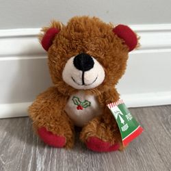 his is a Christmas House 61/2 inch plush sitting holiday bear. 