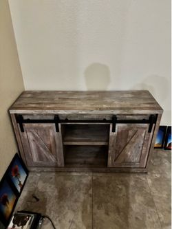 Tv stand all wood the doors open to put dvds inside