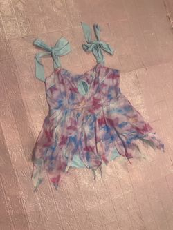 Playful pastel tie-dye mini dress. With mesh butterfly fabric Adjustable tie-shoulder straps. Small front keyhole detail. Handkerchief hem for movemen