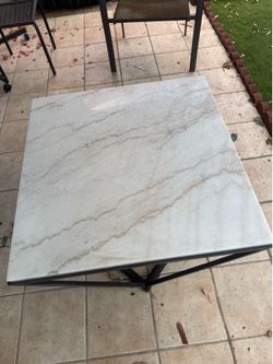 White marble table with black iron cast