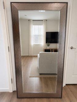 Silver antiqued mirror. 65 3/8” H | 31 3/8l W | 1” depth.