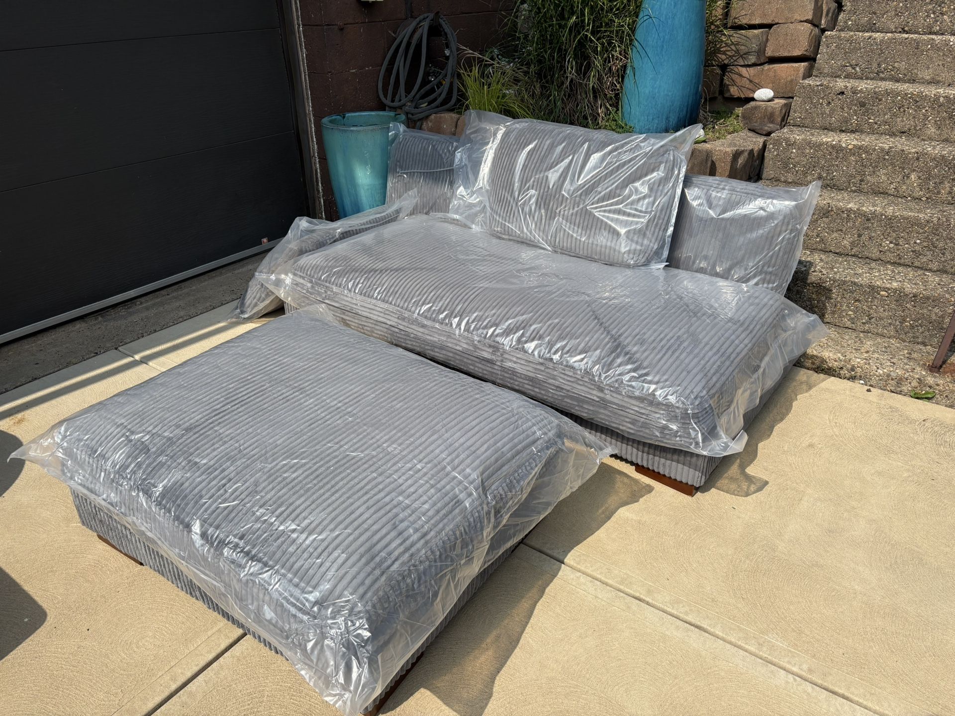 New beautiful gray corduroy armless couch, and a huge ottoman.