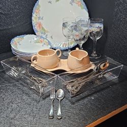 Plates, bowls, wine glasses & silverware. 