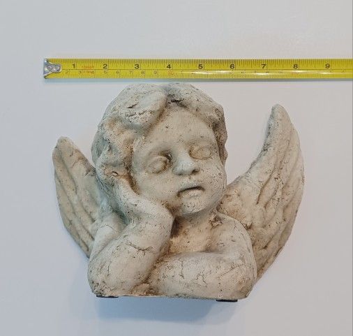 Plaster Cherub in thought