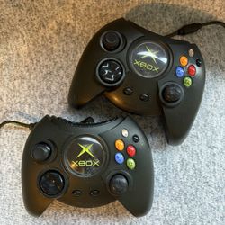 Two black Xbox Wireless Controllers