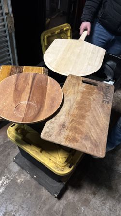 Lot of 4 wooden pizza peels and serving boards used in a commercial setting