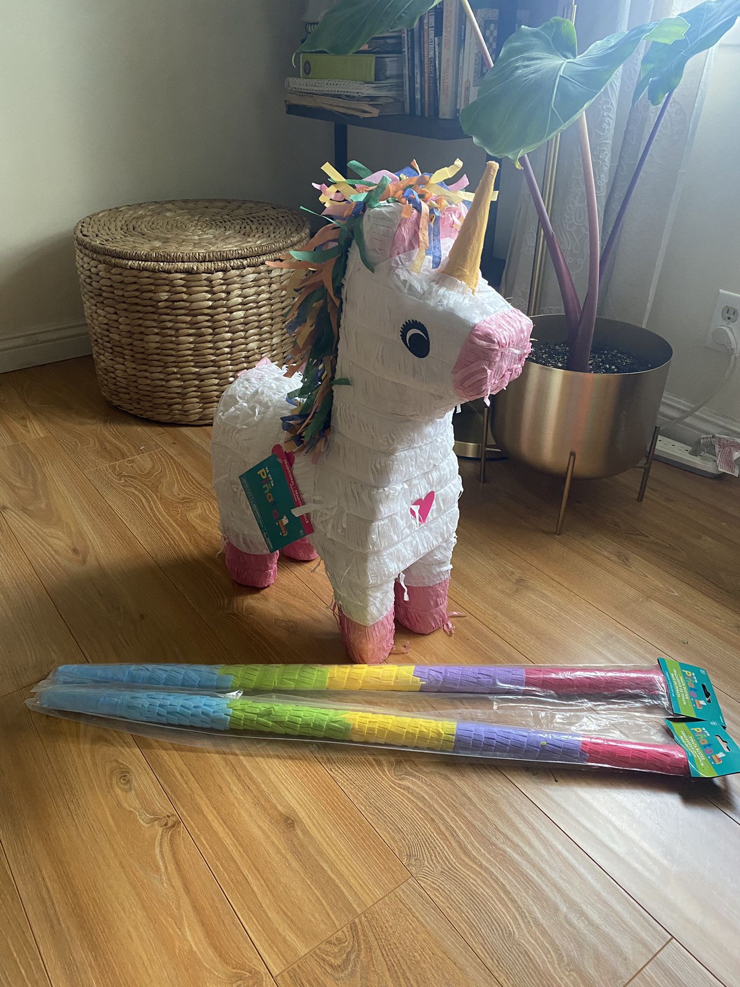 Unicorn Piñata And Colorful Batting Sticks