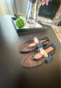 flats with a metallic buckle detail.