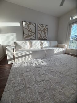 White modern couch and 8x10 area rug