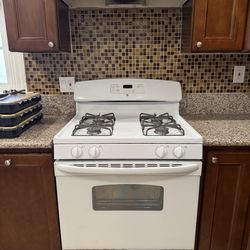 GE used 4 burner gas range and Nutone hood set for sale white