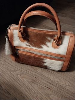 Cowhide and tooled leather purse