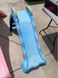 blue Little Tikes 2-in-1 indoor-outdoor wet or dry slide with green handles.