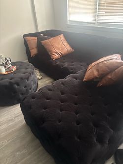 Black sectional and ottoman