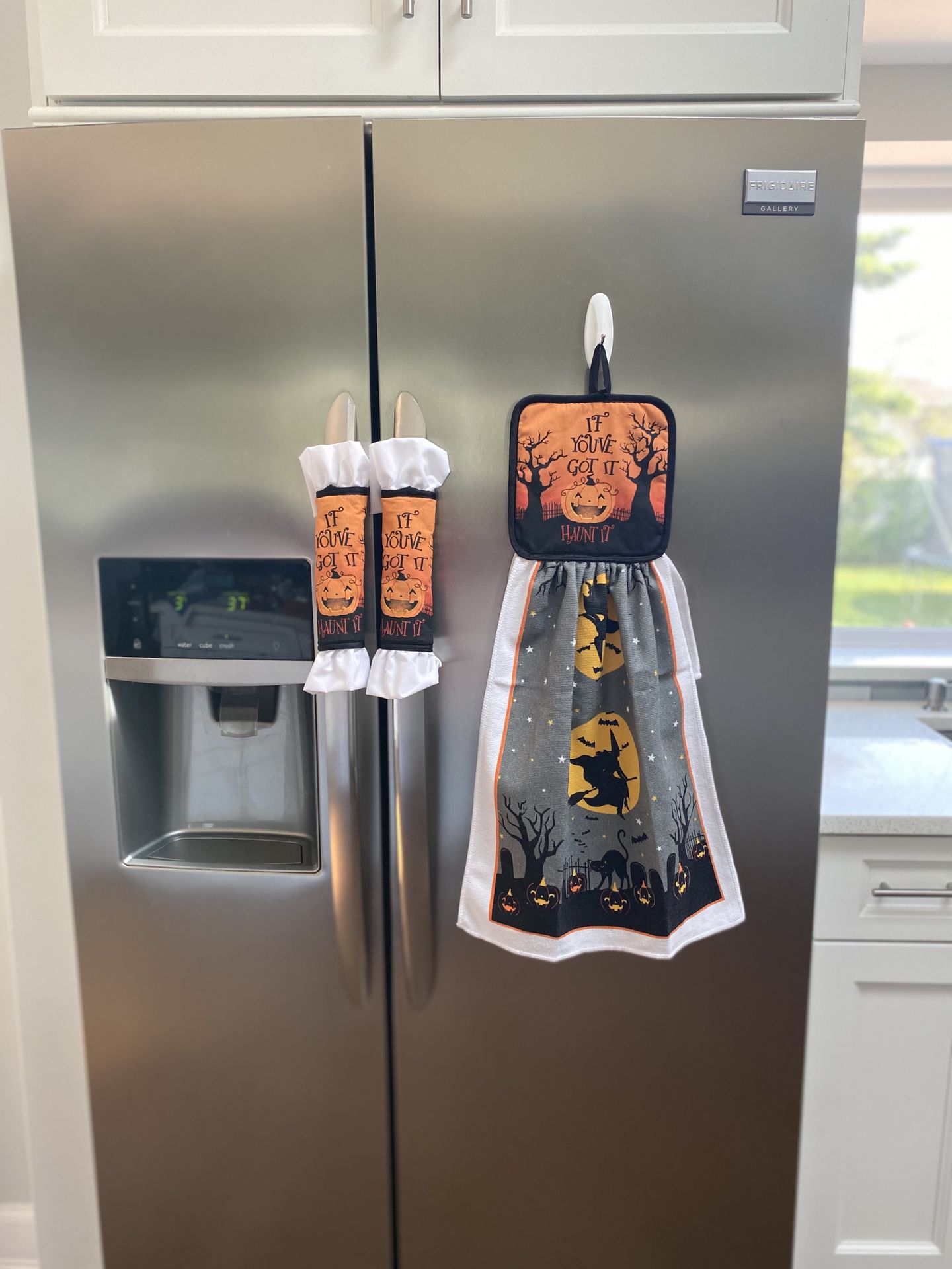 Kitchen towel with decorative pot holders.