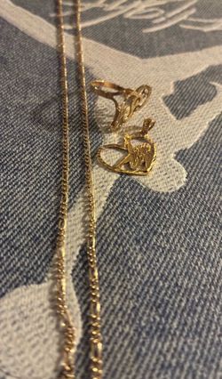 Pendent is 14k and the chain and ring is 10k