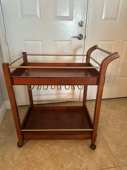 Bar cart with rolling wheels