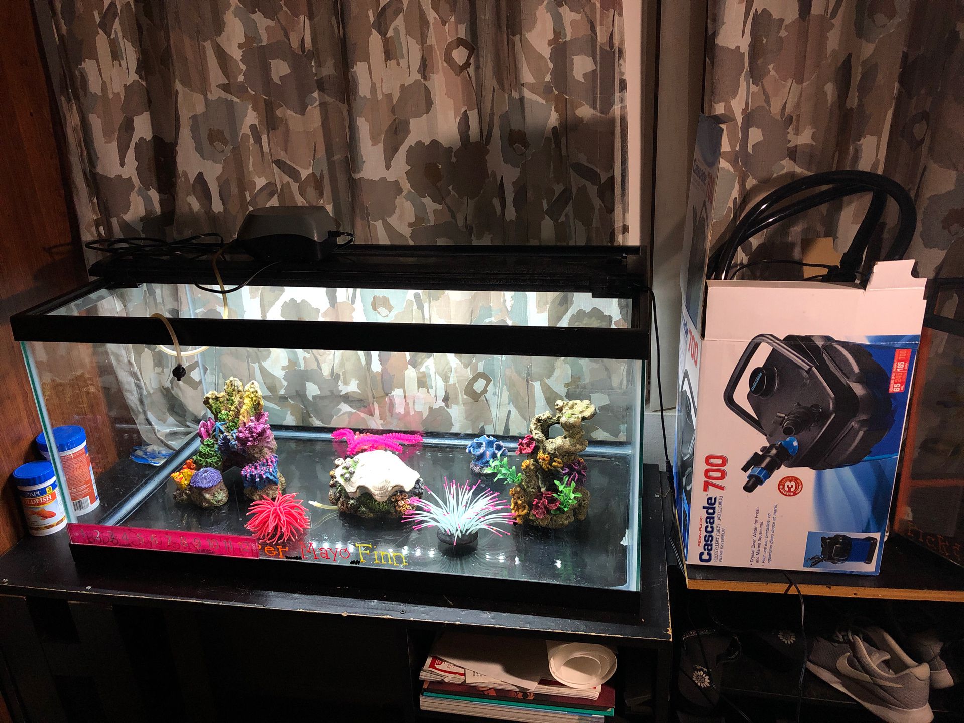 45 gallon fish tank with filter, decorations, oxygen pump, rocks, and light