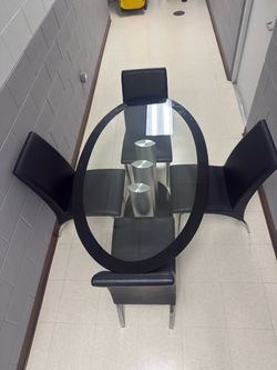 Glass table w / 4 faux leather chairs