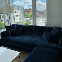 Interior Define Winslow Sofa in Navy Blue Velvet with matching Throw Pillows and Ottoman. In Child and Pet-Free home.
