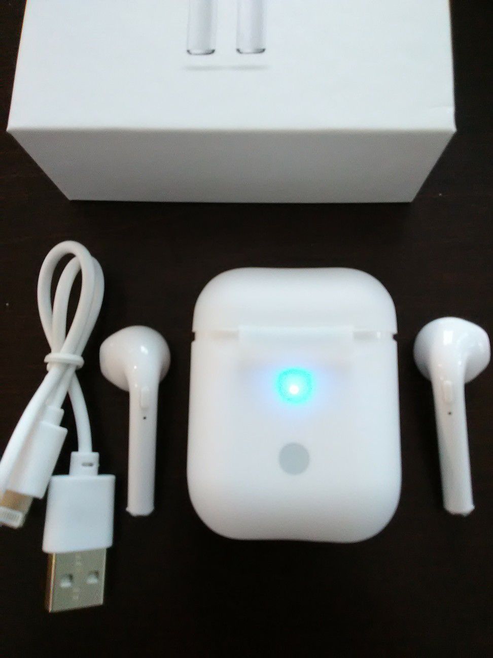 Brand new mini white wireless Bluetooth headphones earbuds with wireless charger box included. These are not airpods but same size