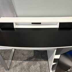 Bell'O Enterprise Desk with integrated Bluetooth speakers, charging station, and a black and white finish with silver legs 4ftx2ftx2’9”ft