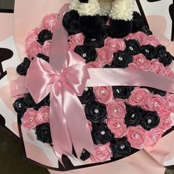 pink and black ribbon rose bouquet with cow plushie