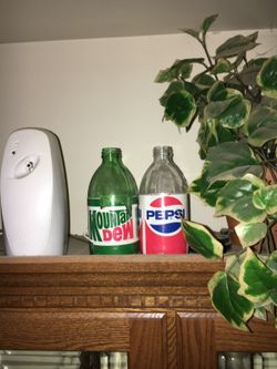 Old Pepsi and Mountain Dew bottles displayed well