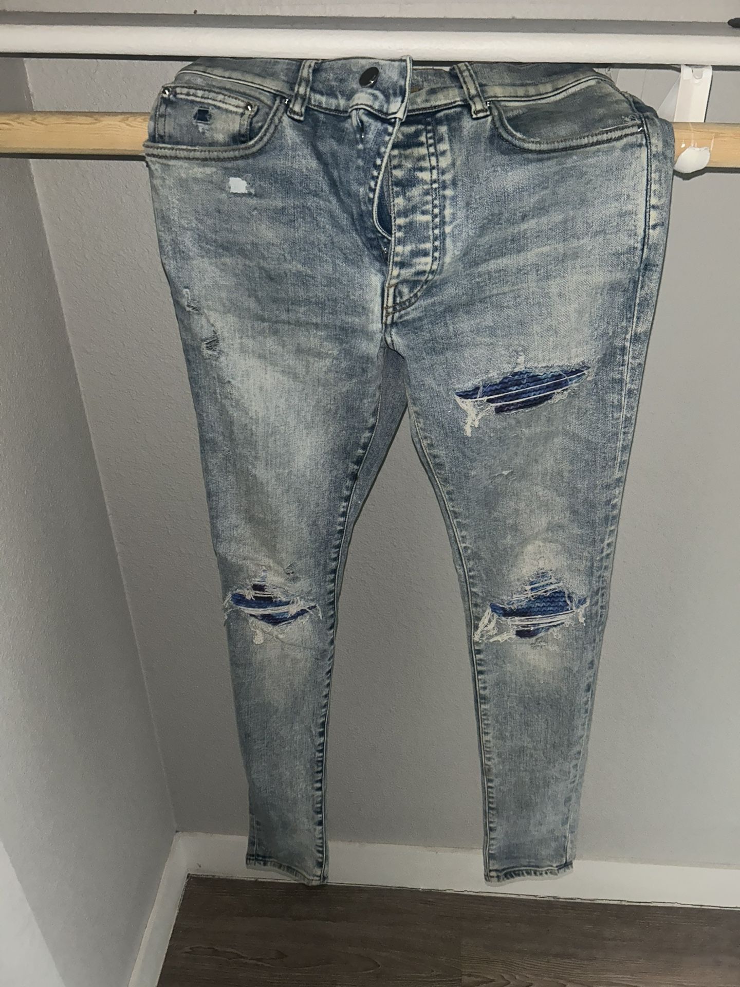 Amiri Distressed Skinny Jeans – Light Wash Blue Patch Repair Denim”