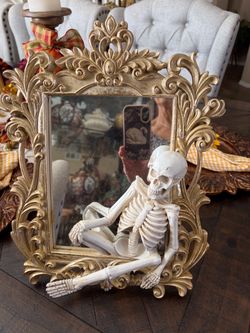 Gold Ornate Mirror with Skeleton Figurine