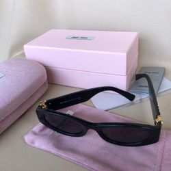 Miu Miu Women's Black and Gold Sunglasses