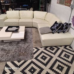 Leather sectional sofa. Beige in color. 