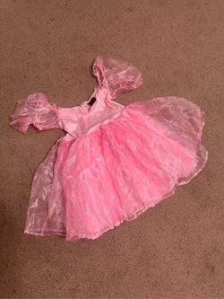 Playful pink mini dress with layered sheer tulle skirt. Puff sleeves and fitted bodice create a classic party look. New Xs pink princess mini dress