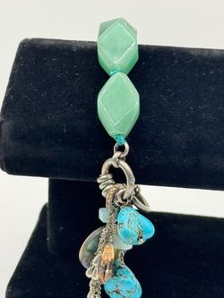 A vintage silver  tone charming  pendant  bracelet  featuring