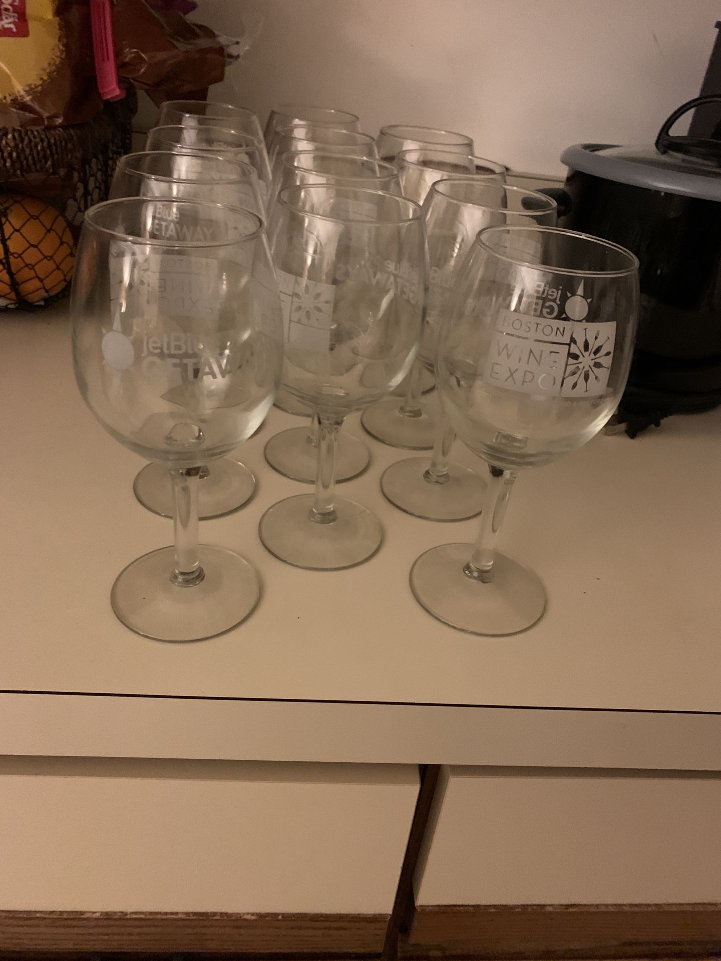 12 wine glasses from the Boston wine expo one side has a JetBlue logo