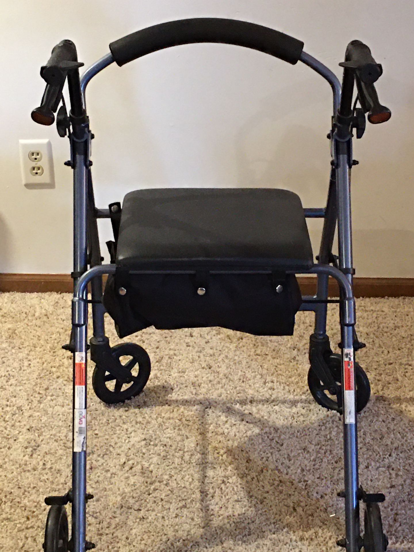 Rolling walker with seat and storage