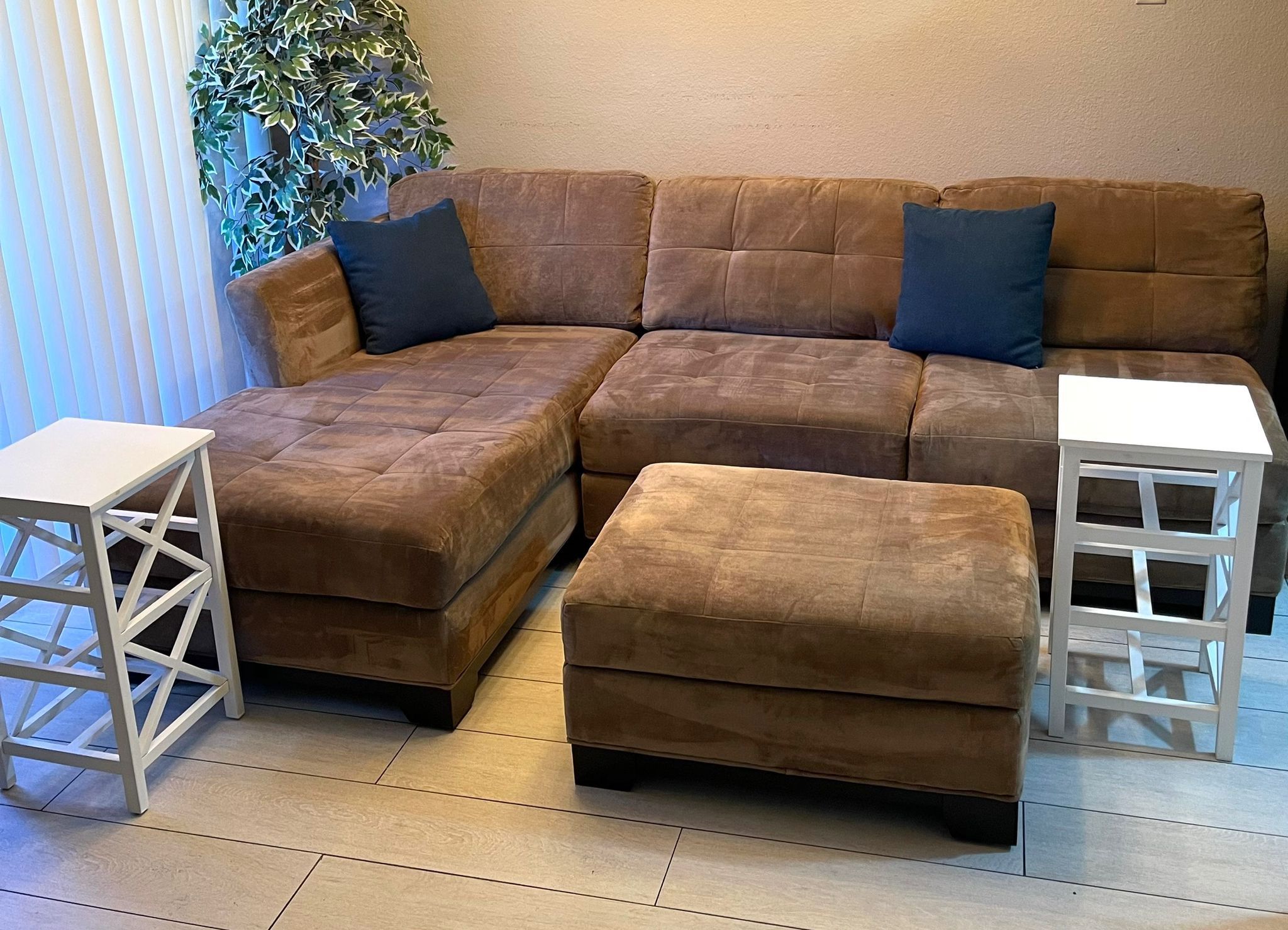 Living room brown L shape sectional couch set with two end tables.