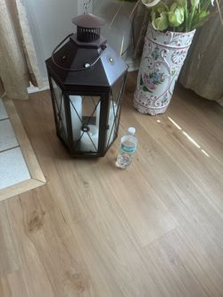 big and heavy brown metal lantern with 3 candles
