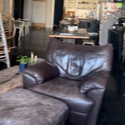 (2) Brown Leather Armchair With Matching Ottoman (worn)