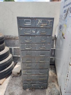 Old vintage cabinet, 22 drawers. Metal frame aluminum drawers. Not in good shape. All drawers open & close. some of the drawers don't seal all the way