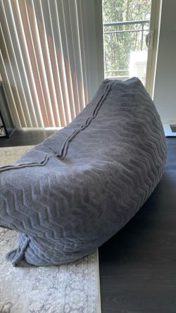 Sofa and foam- filled floor pillow