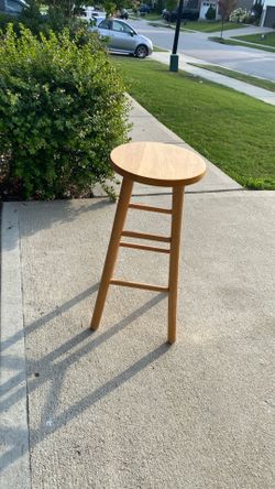 Two brown hardwood stools
