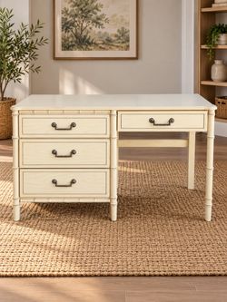 Cream-colored wooden desk has faux bamboo detailing on the legs and frame.  46” x 18"d x 30''h