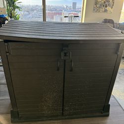 Large Brown Storage Shed and Patio Chair