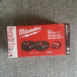Two Milwaukee Batteries And Charger