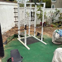 Half rack squat rack for weightlifting, including barbell with no weights.