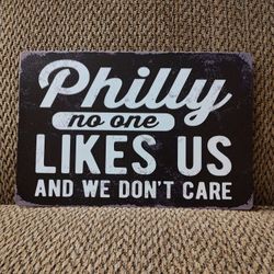 PHILLY NO ONE LIKES US METAL SIGN.  12" X 8".  NEW.  PICKUP ONLY.