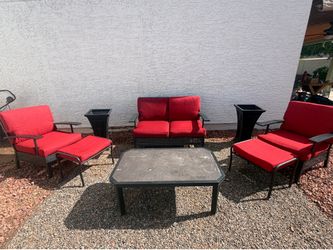 Outdoor patio set with red cushions and self watering planters
