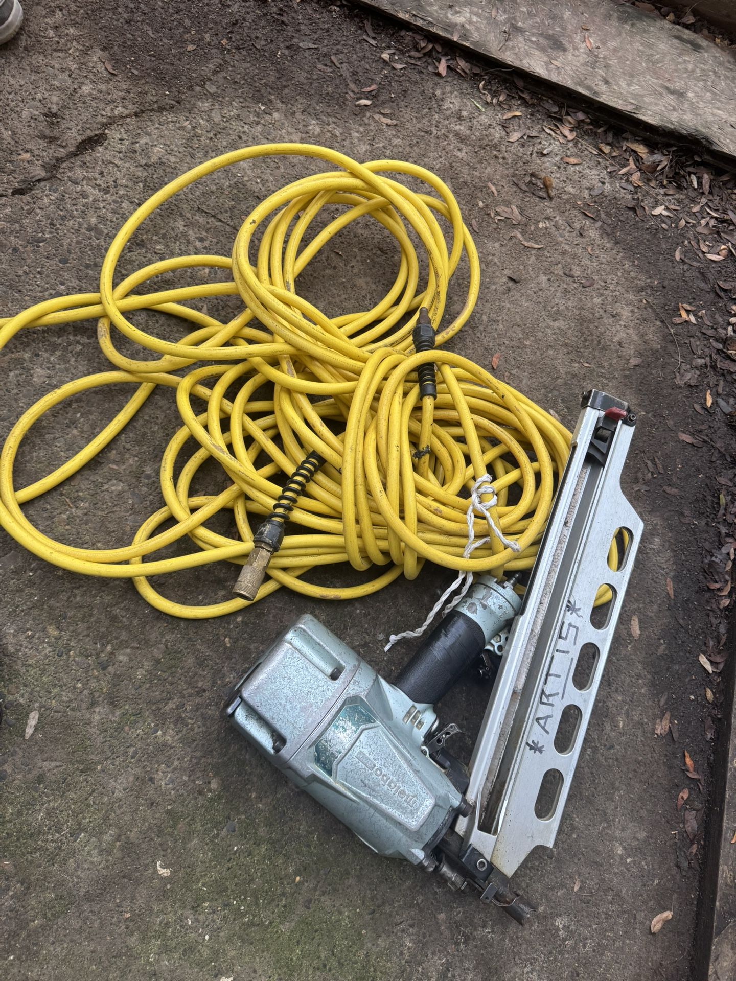 Nail Gun With The Air Compressor Hose