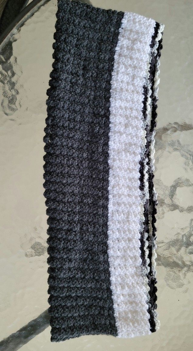 crocheted beautiful gray white and tri-color cowl. the dark gray is cashmere yarn. 24" x 8".