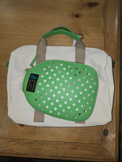 Dooney and Bourke pickleball bad canvas bag with green leather accents